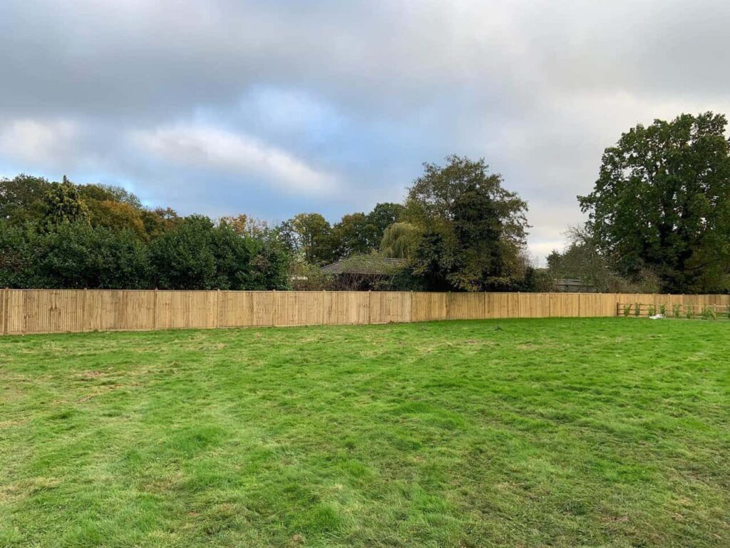 This is a photo of feather edge fencing installed around the edge of a field by Fast Fix Fencing Uckfield