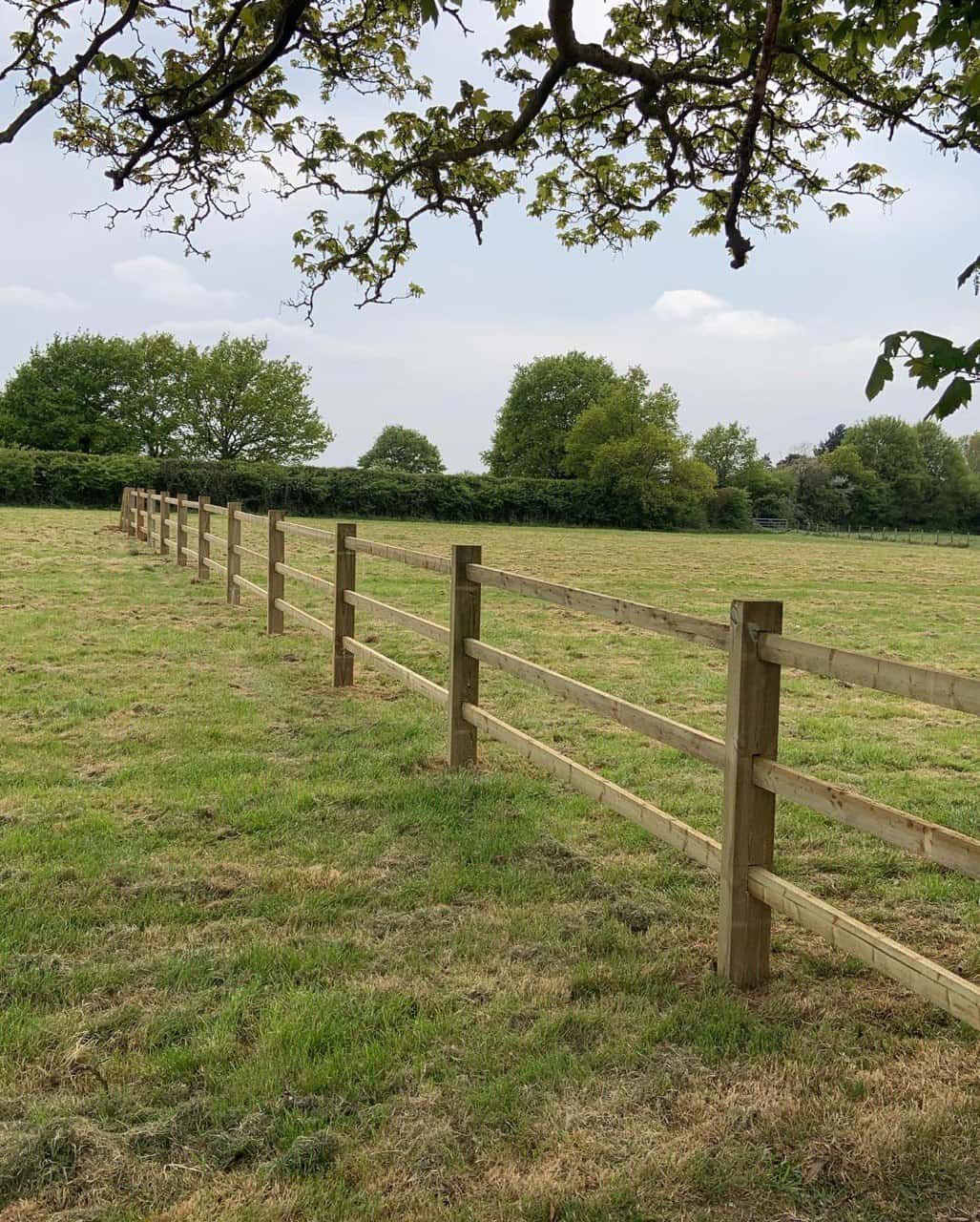 This is a photo of a post and rail fence installed in a field by Fast Fix Fencing Uckfield